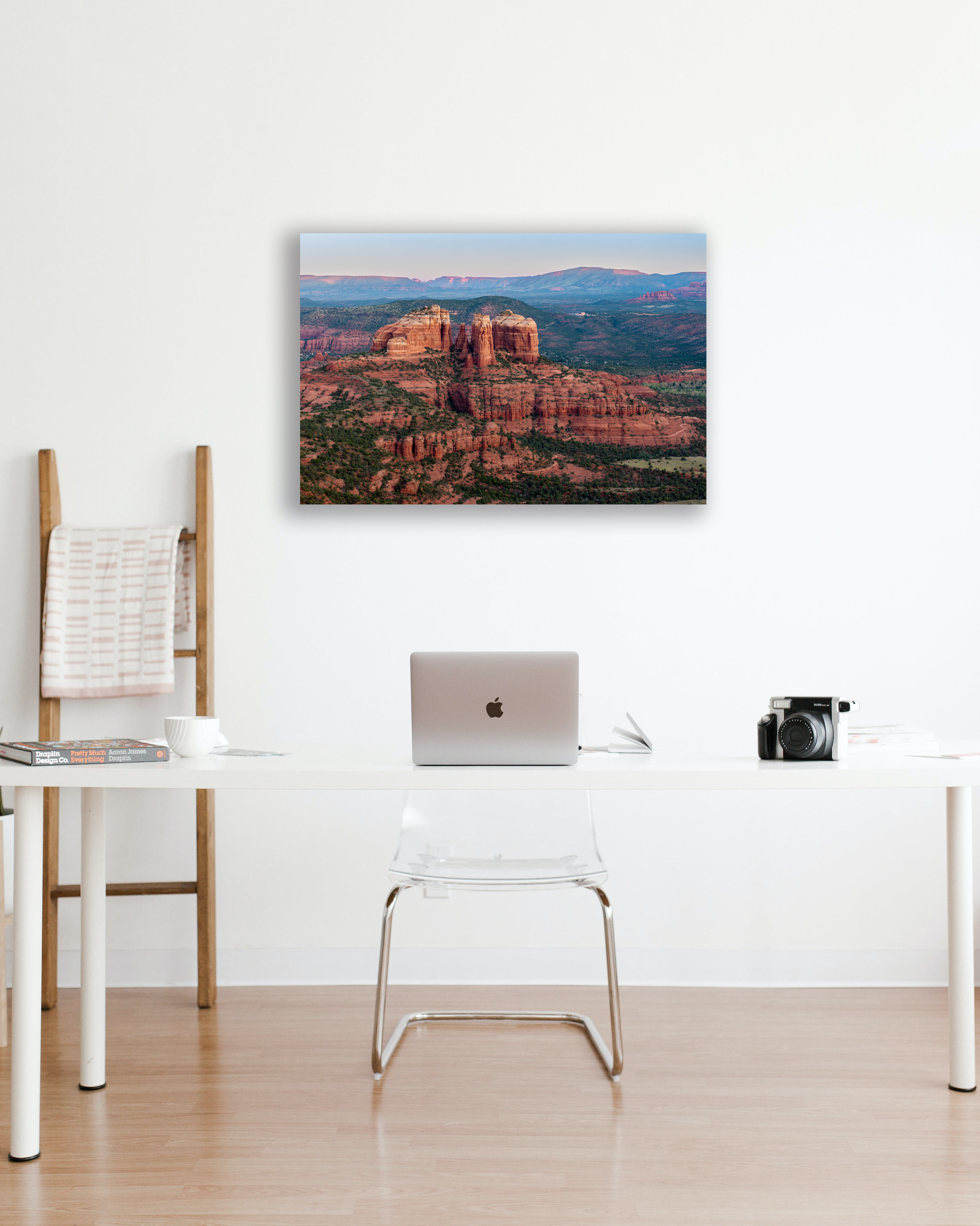 A photograph of the southwest desert hang above an office desk on a white wall.