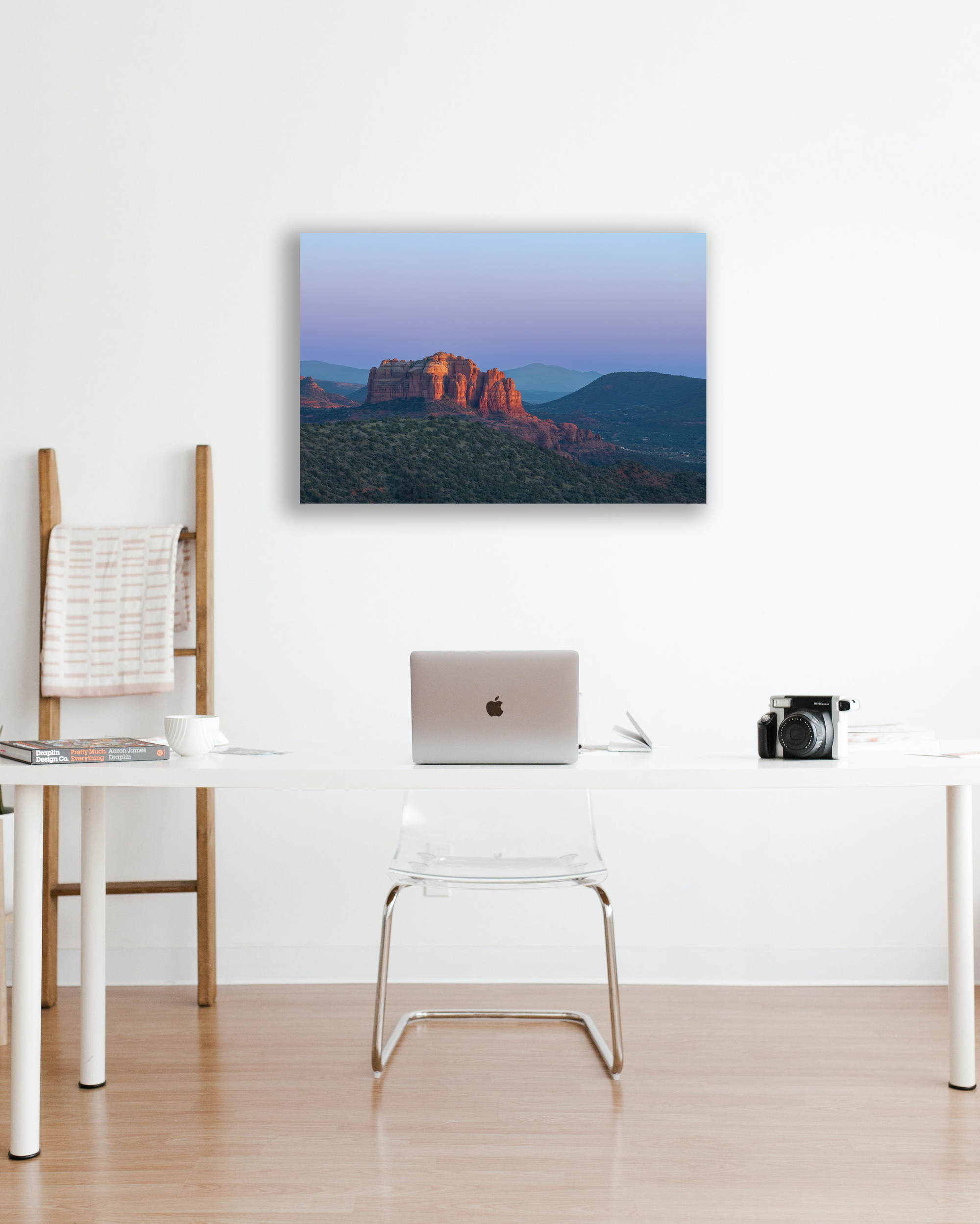 An office wall is decorated with a fine are photograph of a desert mesa and surrounding landscape.
