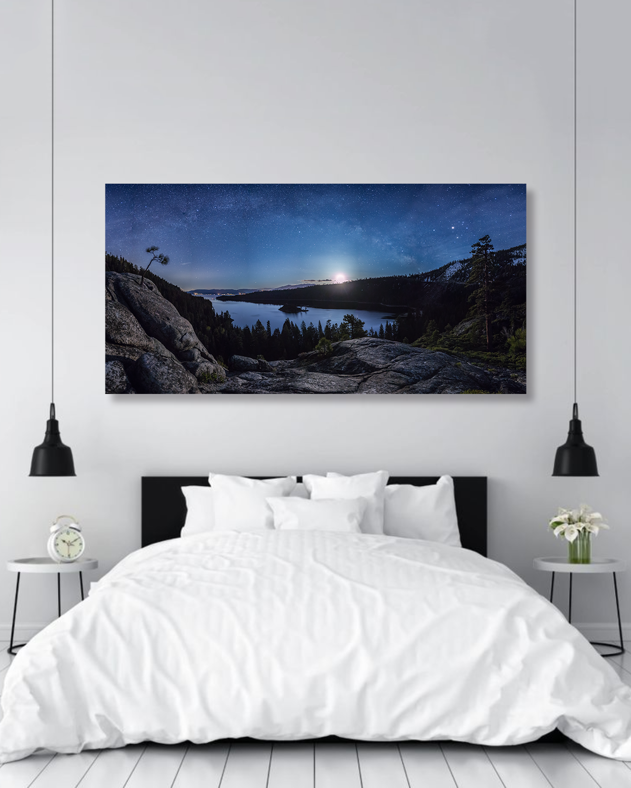 The Milky Way arches above Emerald Bay in a photograph hanging above a bed  in a master bedroom.