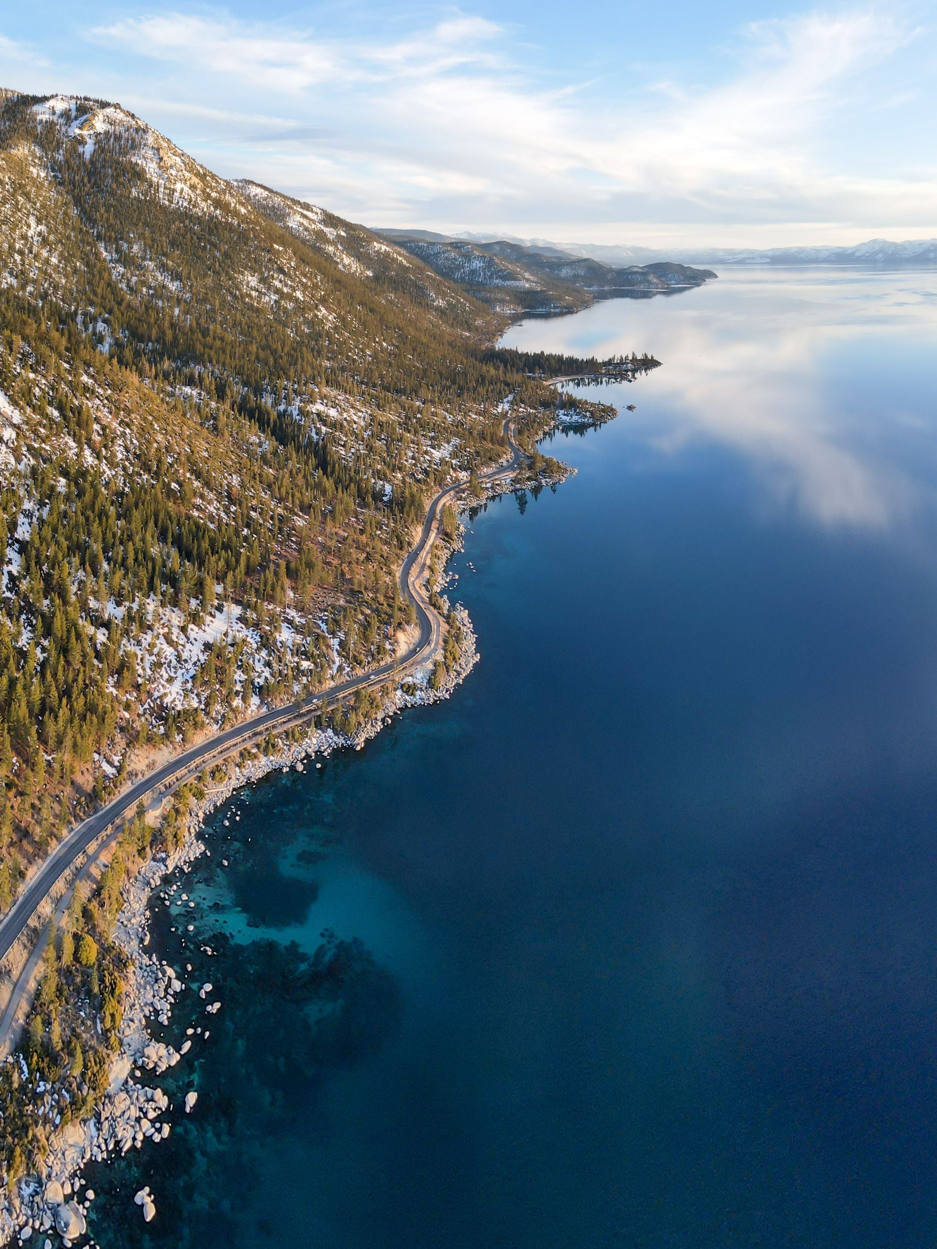 Turquoise blue waters and granite stones line the shore of Lake Tahoe.