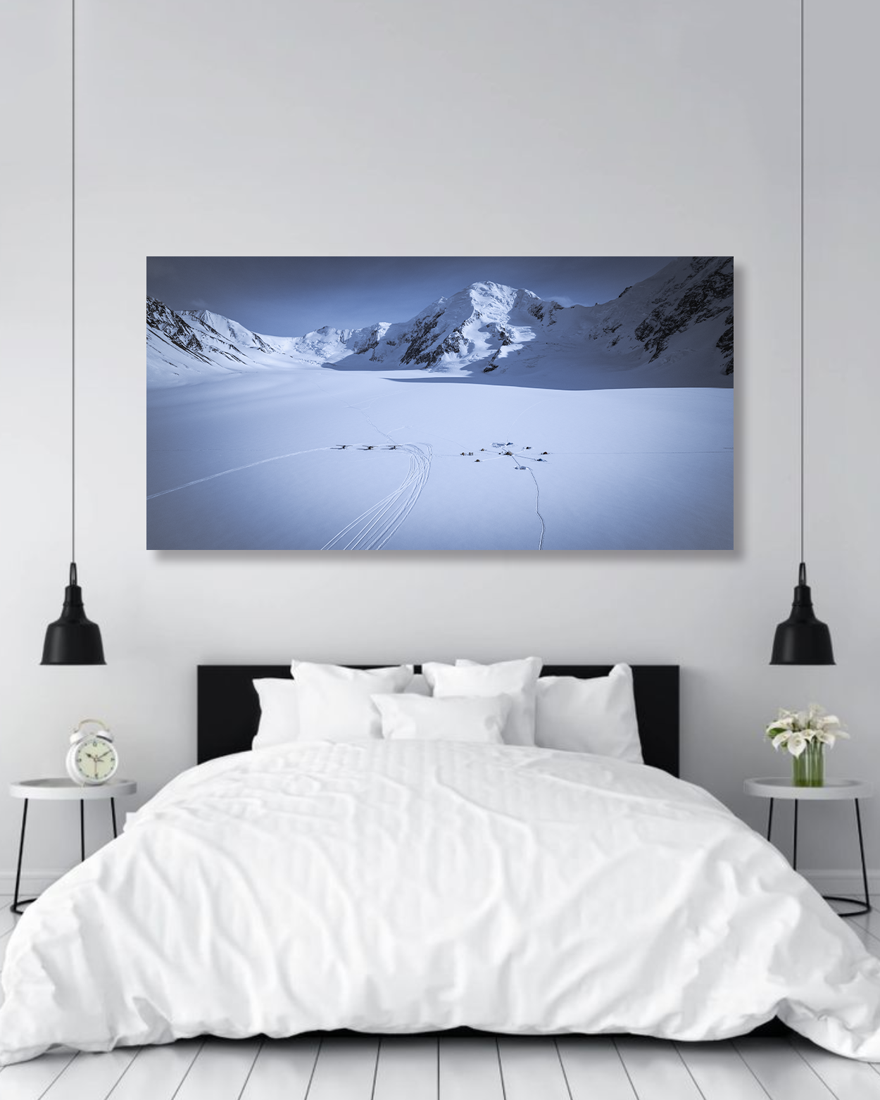 A photograph of a snow camp in Alaska hangs on a wall in a master bedroom.