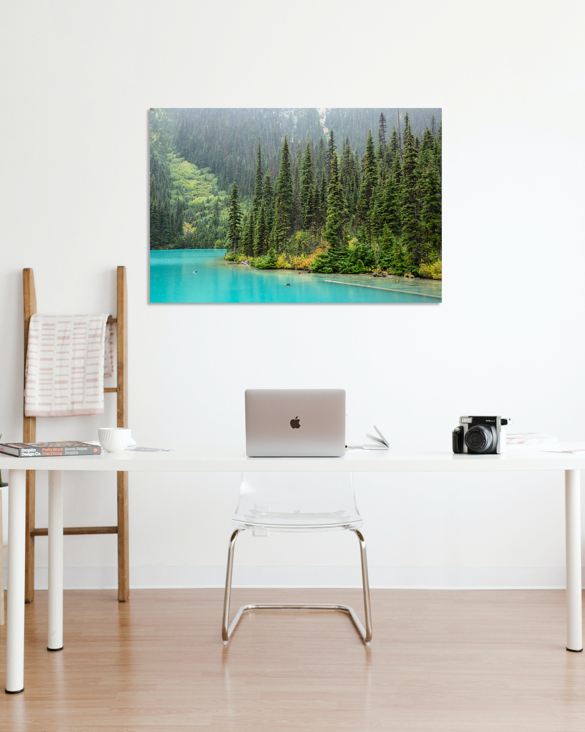 An office wall showcases a fine arts image of turquoise waters.