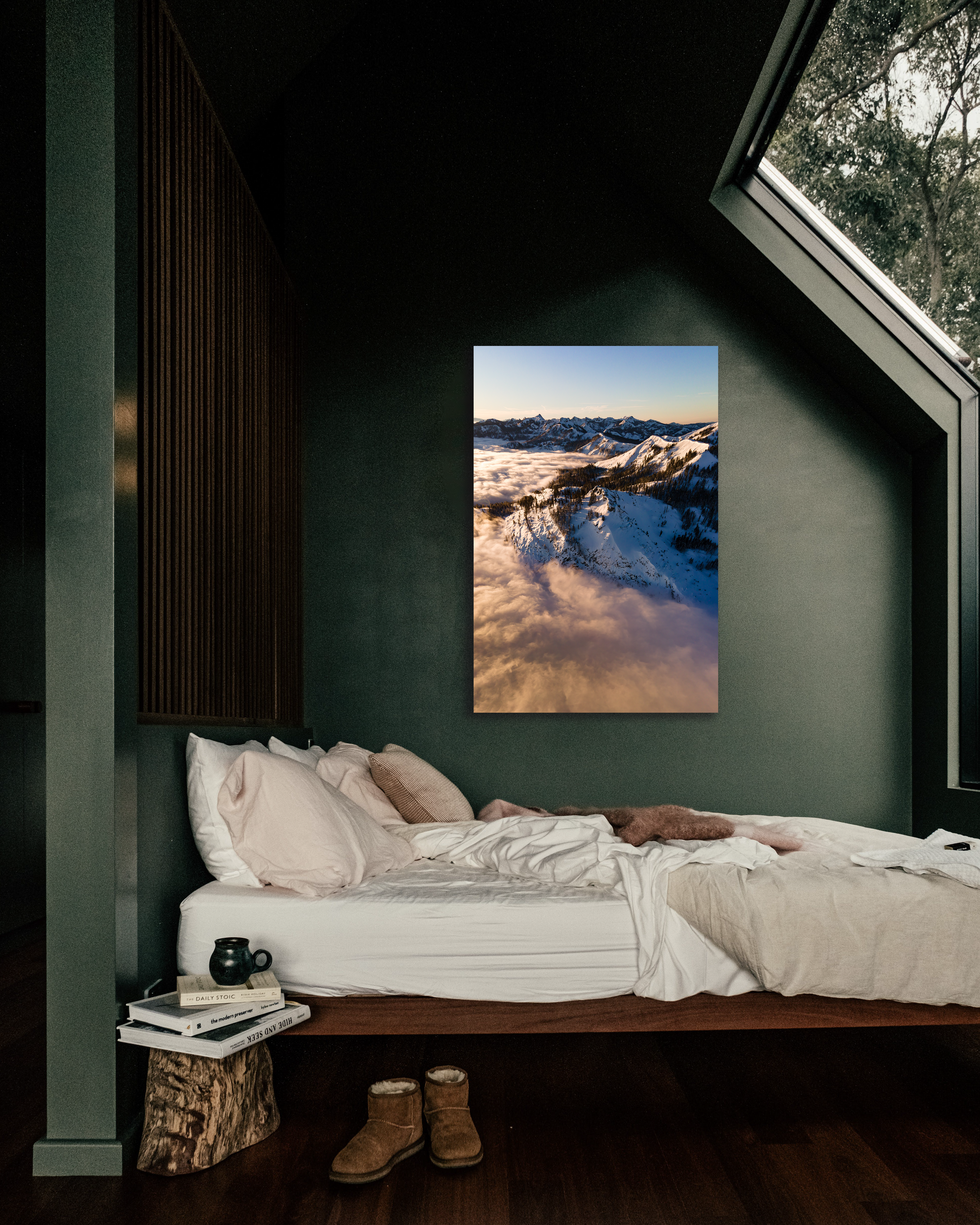 A green bedroom wall showcases a fog laded image of snowy mountains.