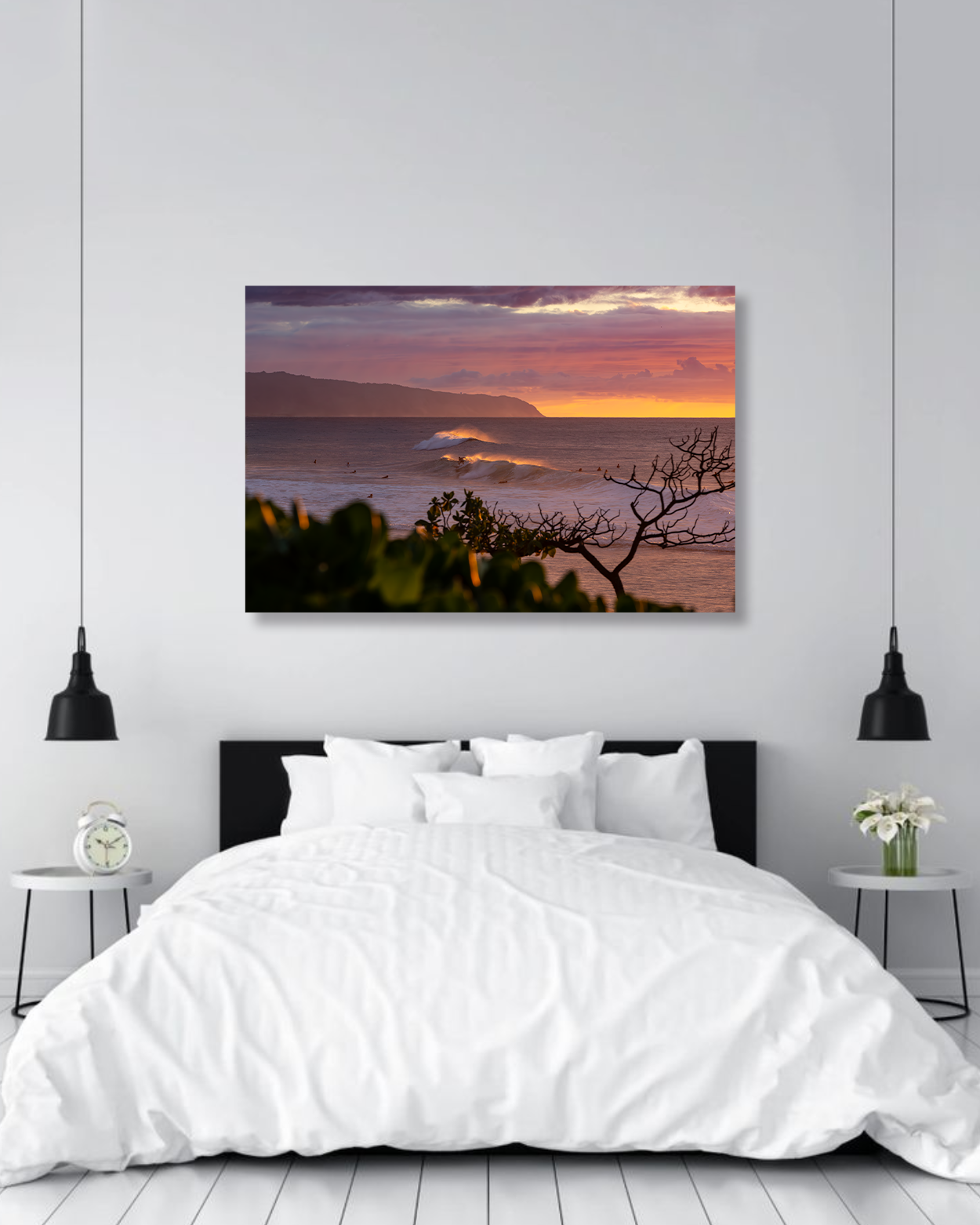 A warm sunset image of surfers hanging on a bedroom wall.