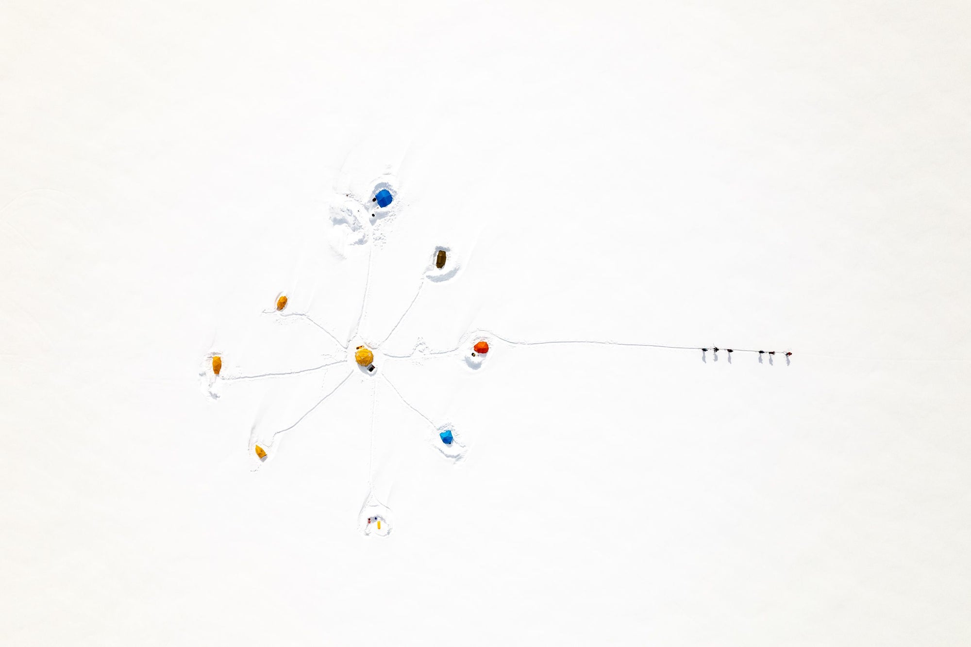 A birds eye view of a snowy campsite.