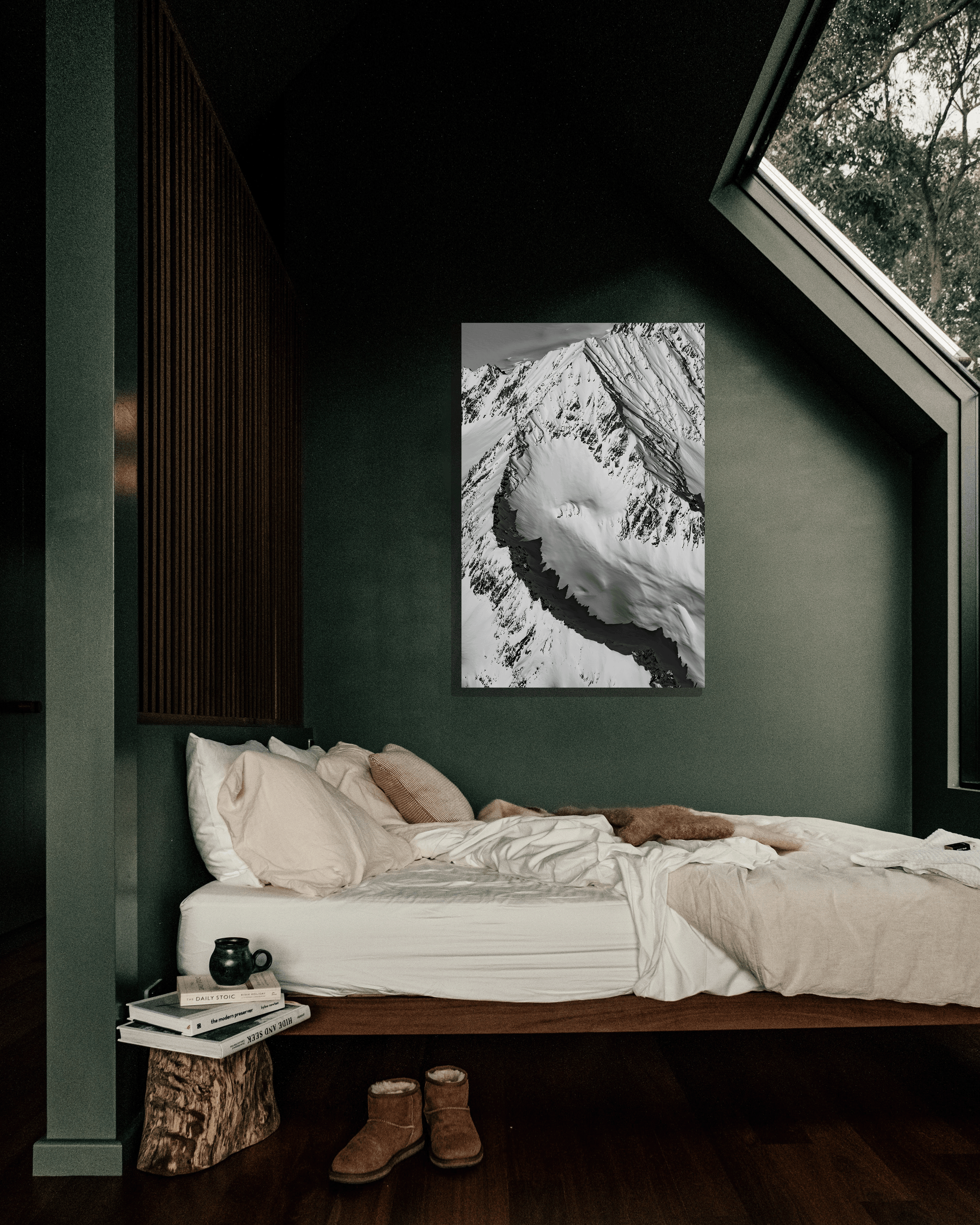 An alcove wall in a bedroom is decorated with a fine art photograph showcasing the jagged peak of Alaska.