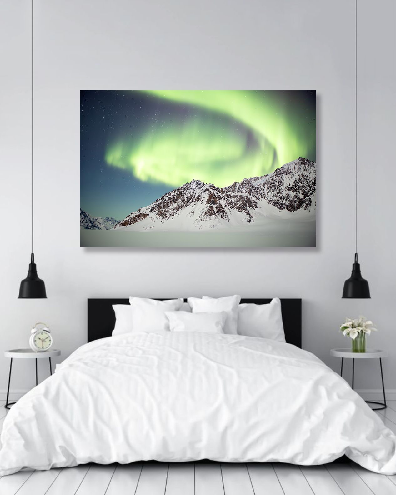 A master bedroom wall showcases a fine art photograph of the Northern Lights dancing above jagged Alaskan peaks.