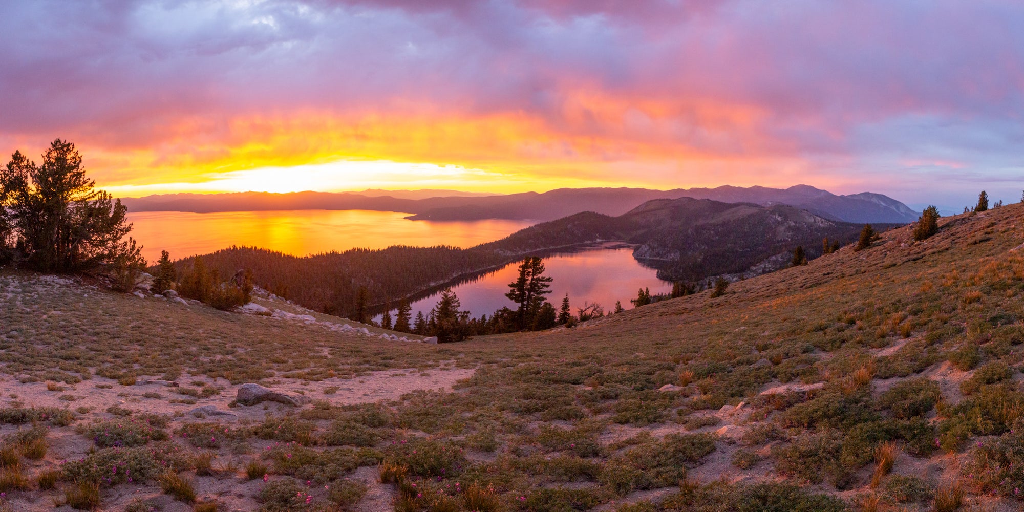 The sun rises over two mountain lakes in Tahoe.