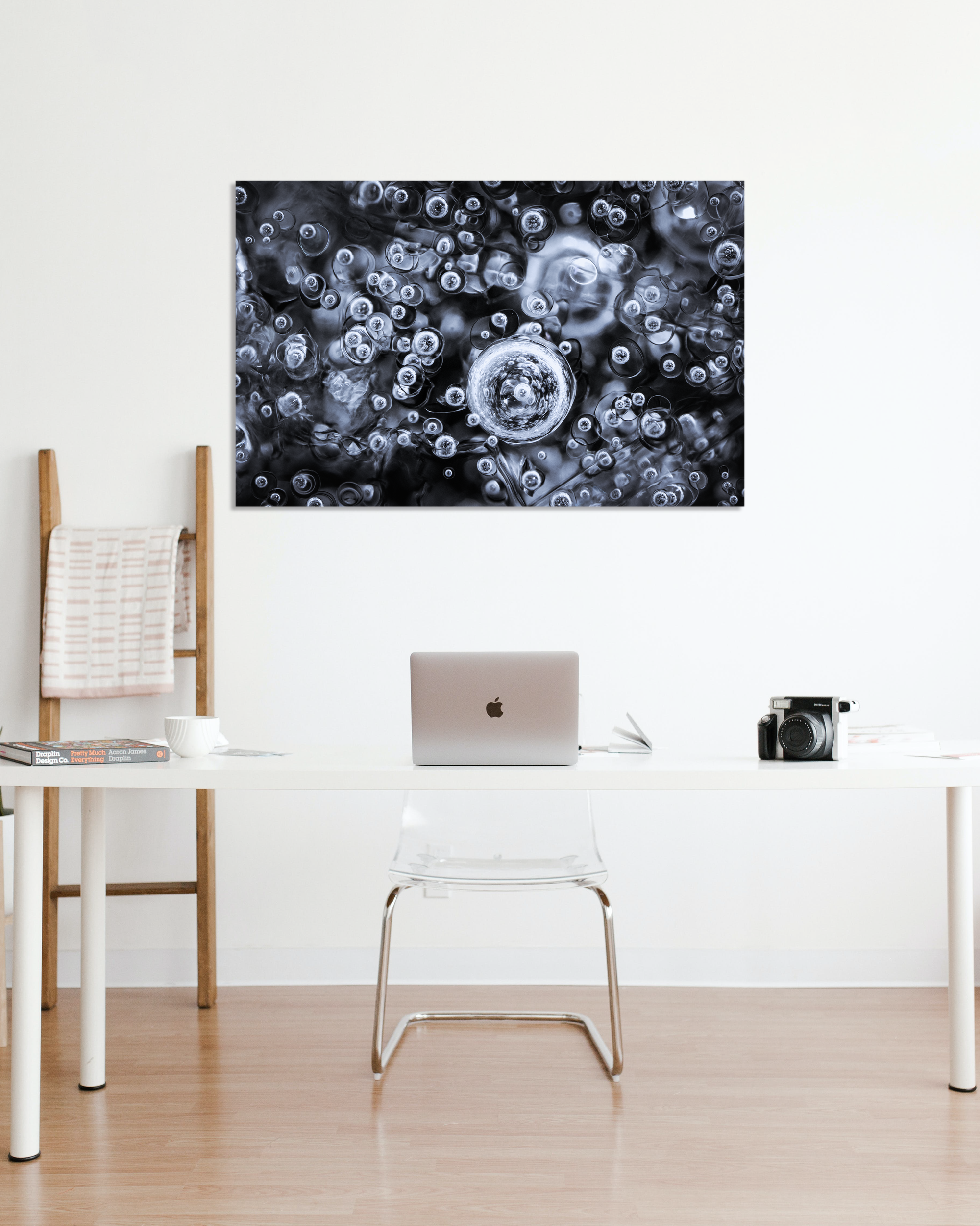 A small office is decorated with a photograph of frozen bubbles of water.