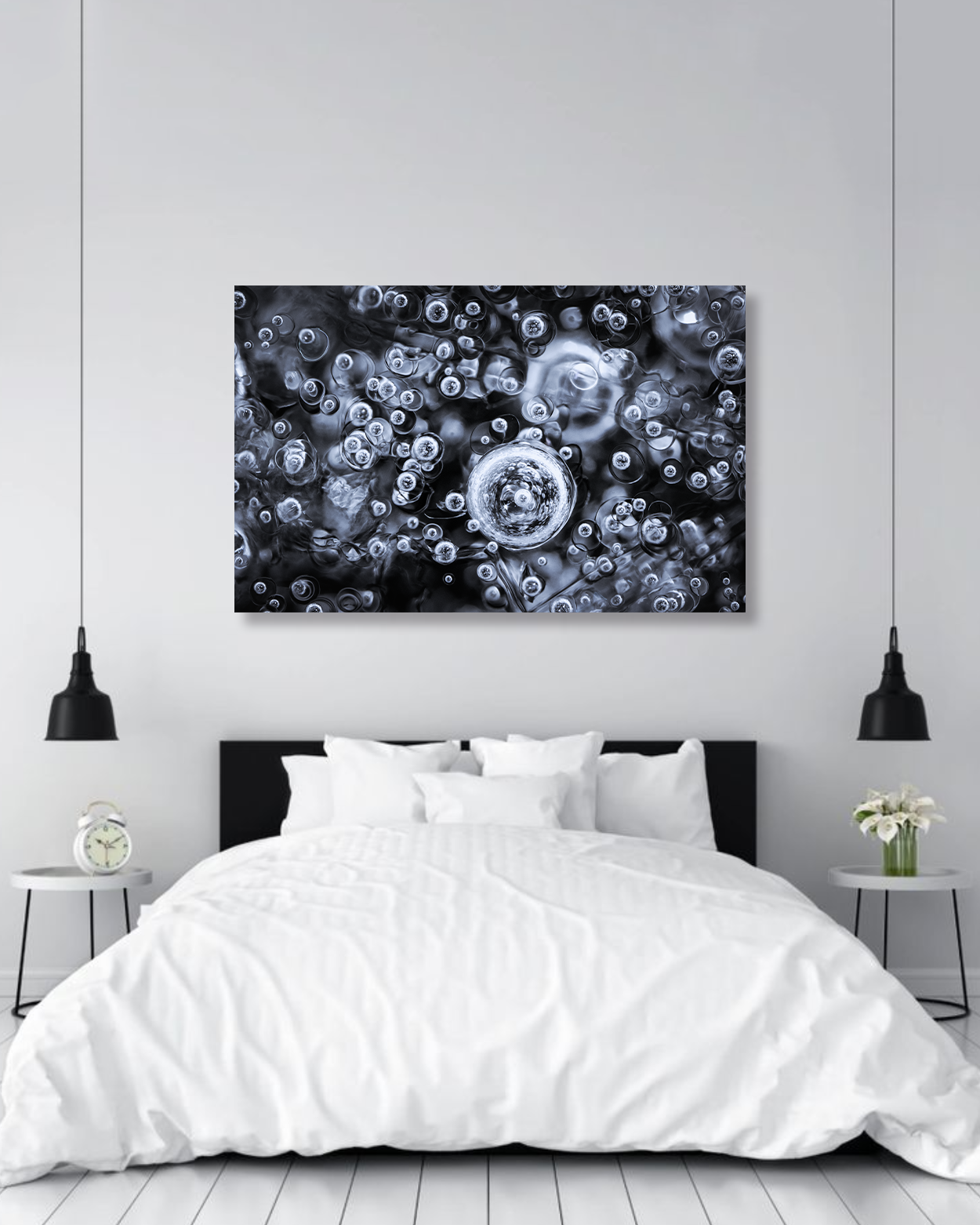 A large fine arts photograph of frozen bubbles of water hangs above a large comfy bed.