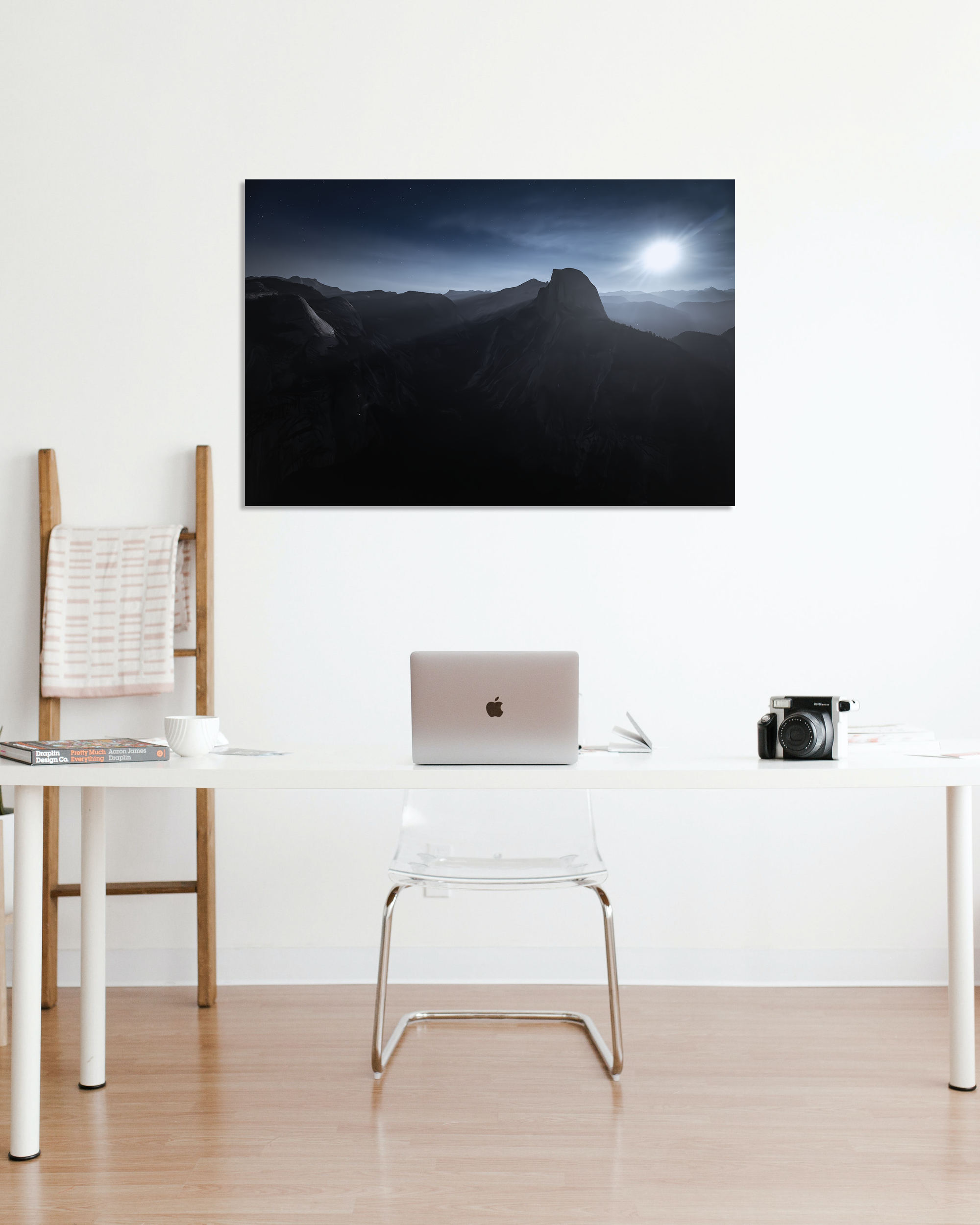 The majestic peaks of Yosemite's Half Dome are showcased in a photo hanging above a small desk.