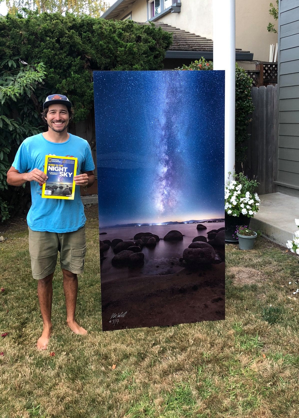 Nick Cahill stands next to a large print of the Dark Needle, his photo that landed him on the cover of National Geographic.