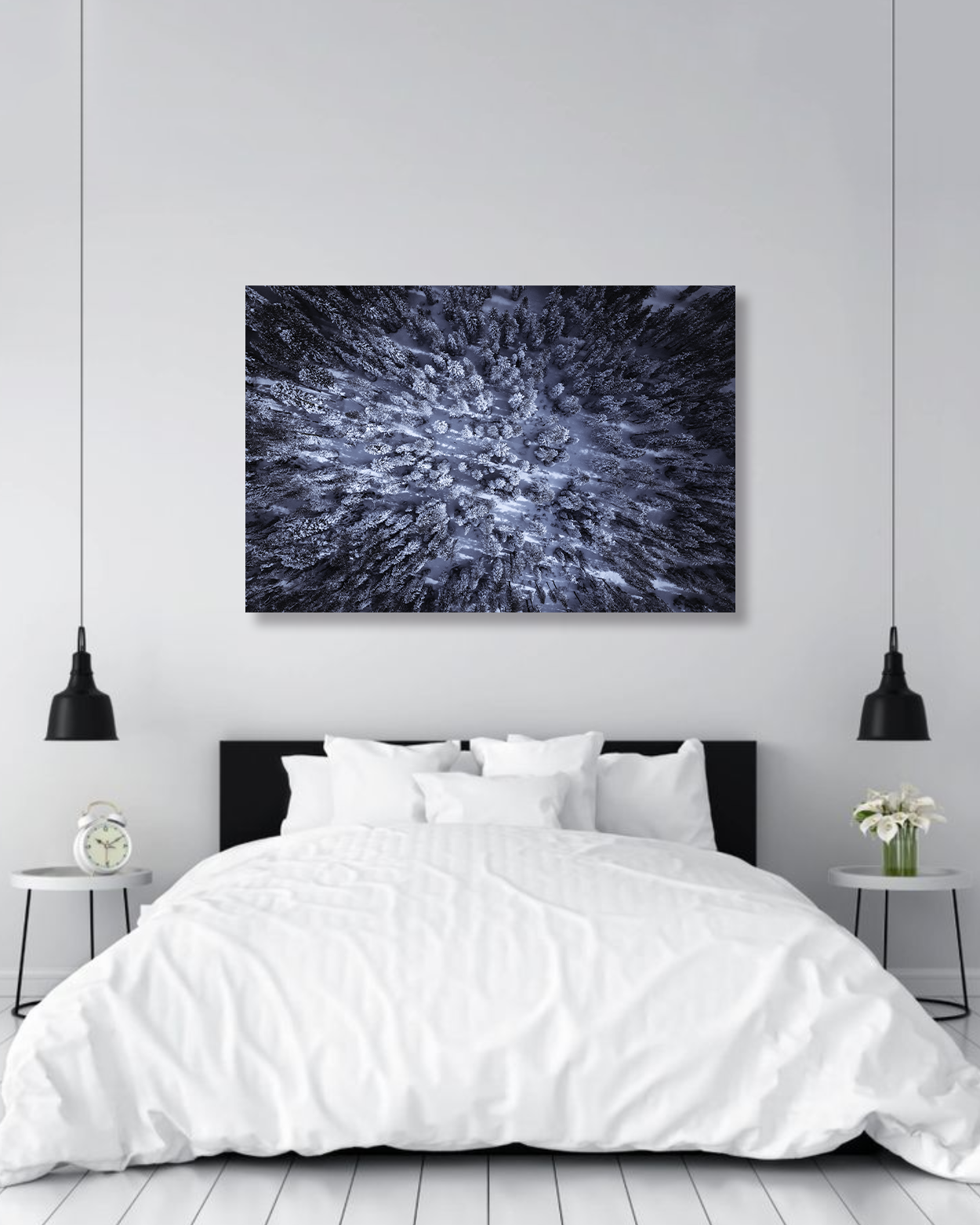 A birds eye view photograph of snowy pines hang above a bed.