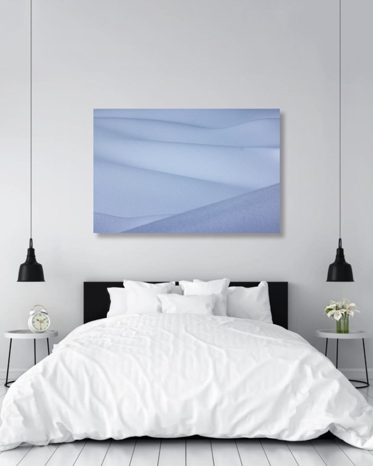 Snowy drifts are highlighted in fine arts photograph hangs above a large comfy bed.