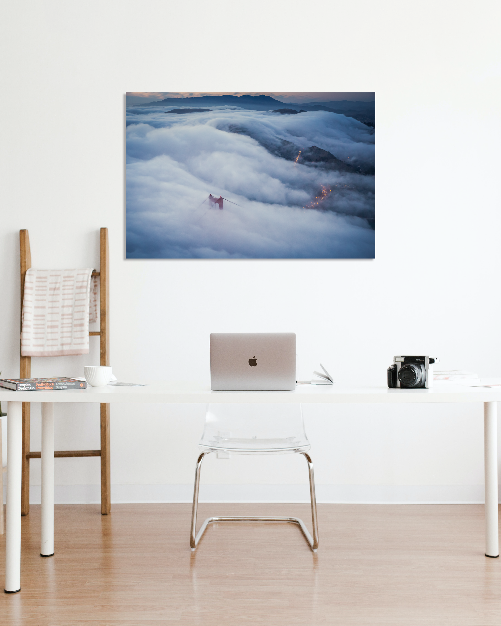 A photograph of the Golden Gate Bridge cloaked in fog hang in an office.