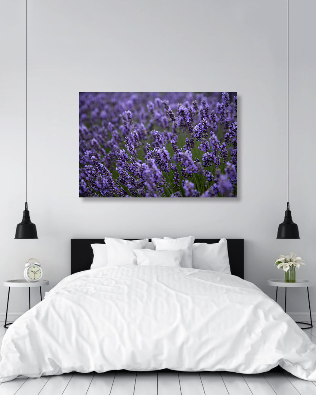 A photograph of purple lupine flowers hanging on a bedroom wall above a bed.