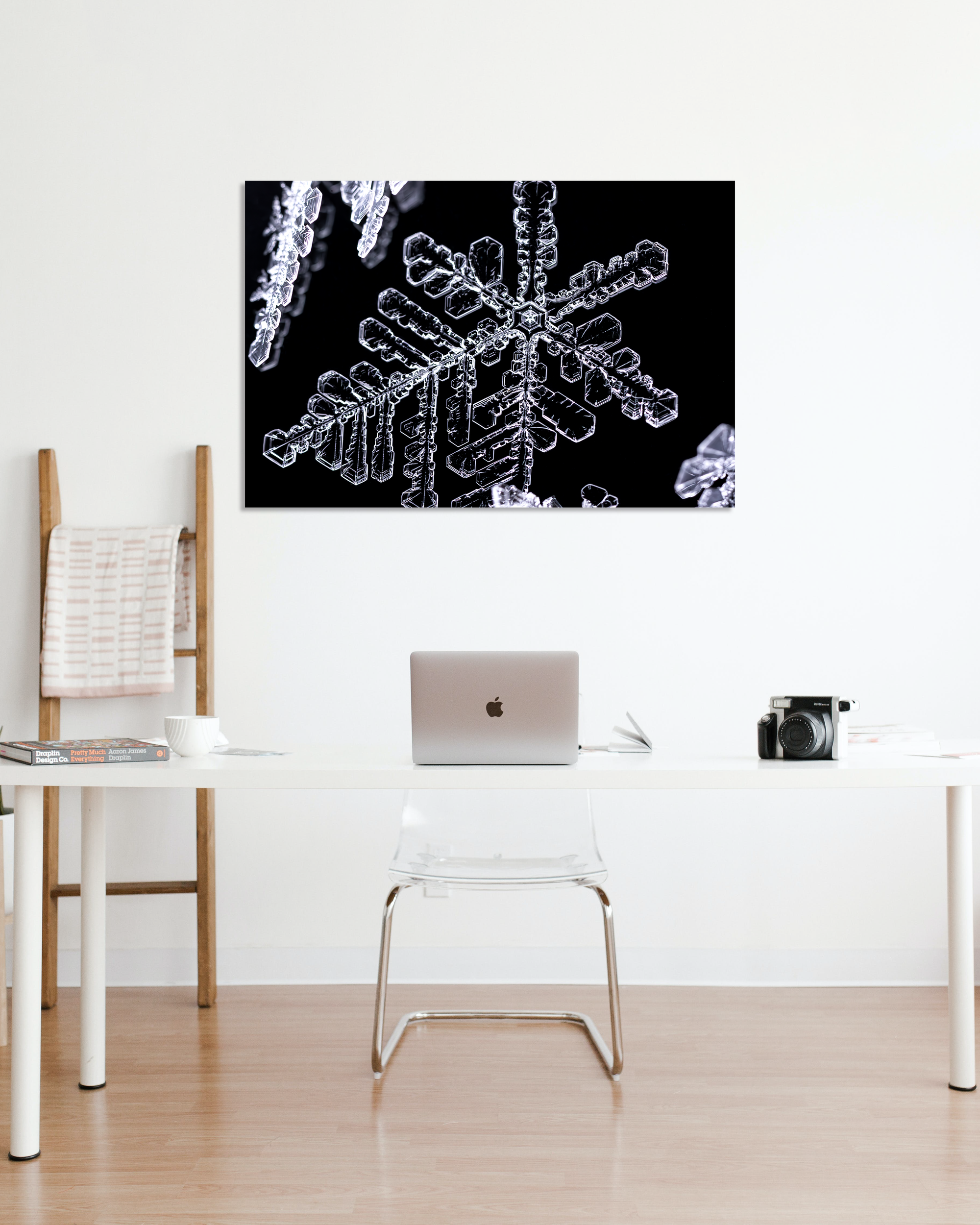A fine art photo print of snowflakes hanging in an office.