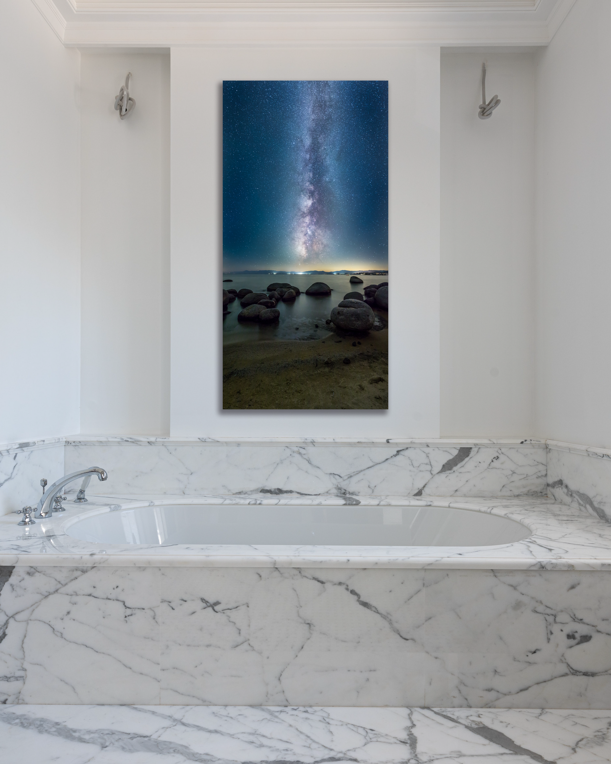 A stunning photo of the Milky Way above Lake Tahoe hangs on the wall of a marbled bathroom