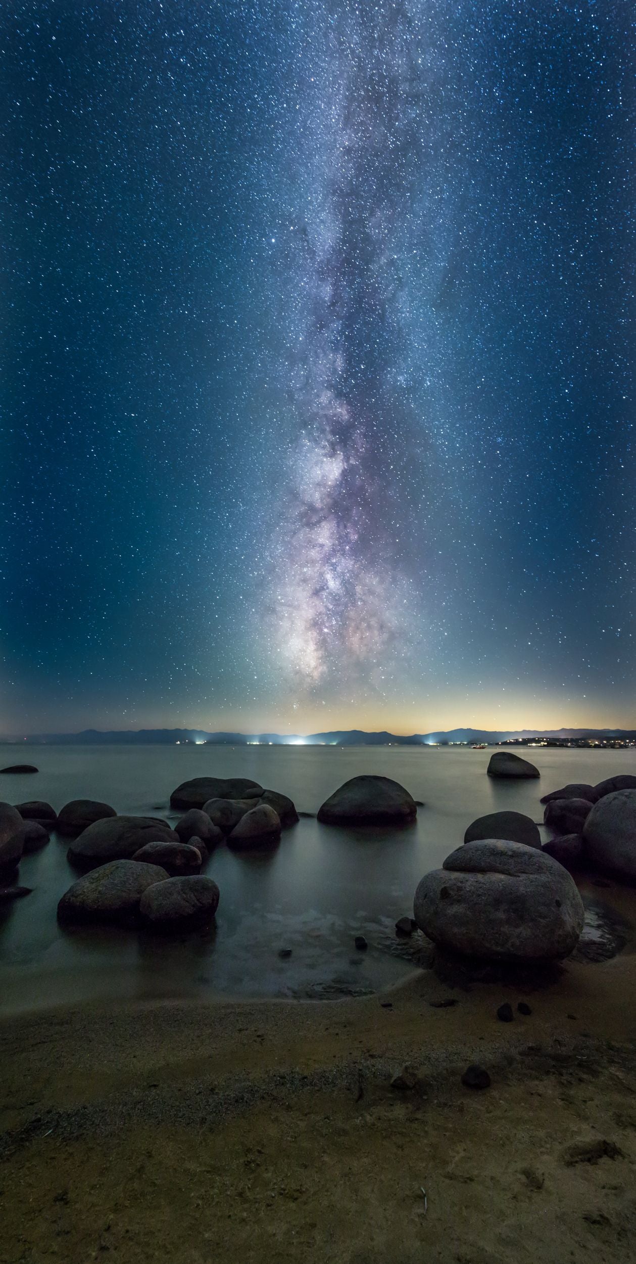 The Milky Way above a sandy beach on Lake Tahoe.