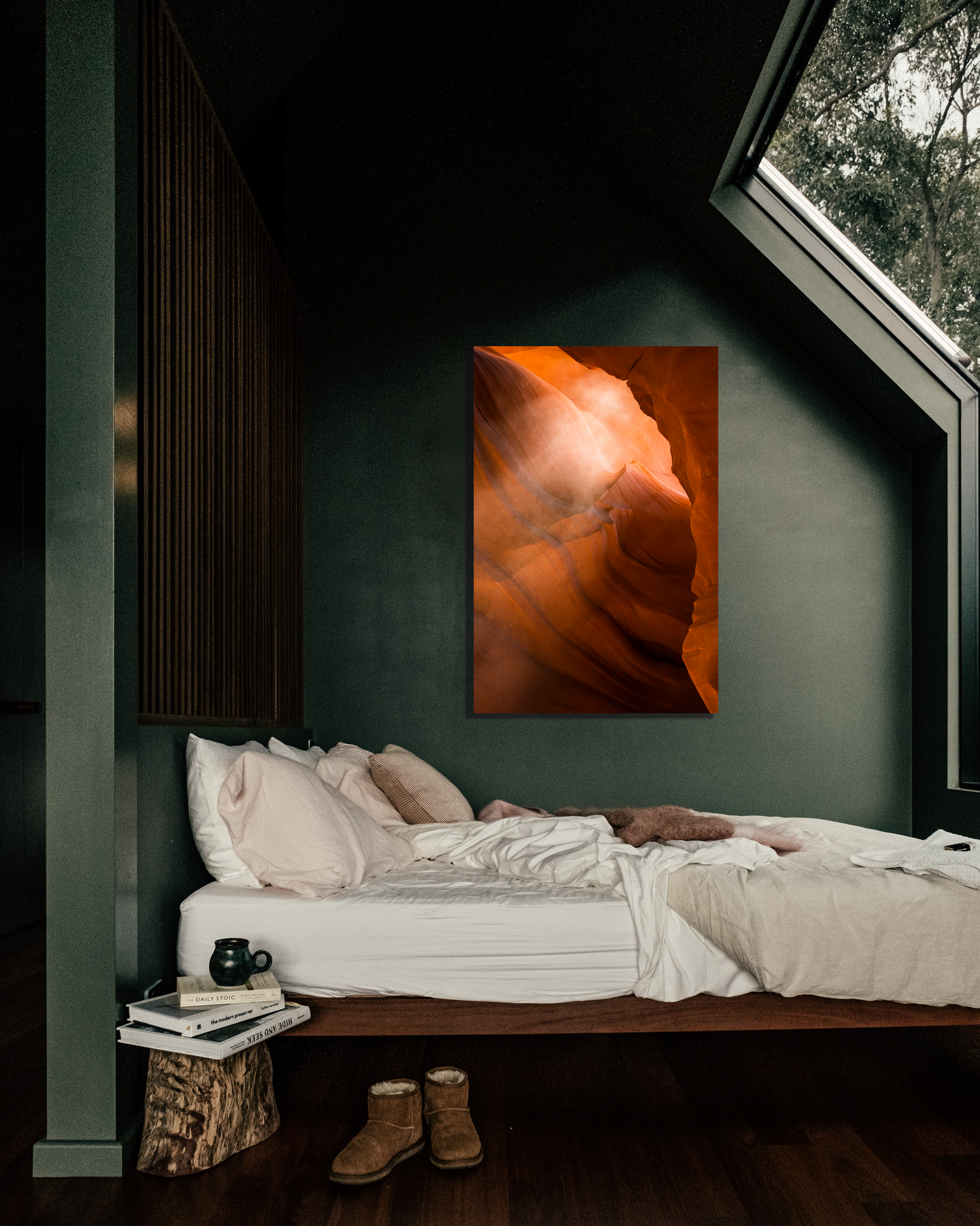 A green bedroom wall showcases the vibrant oranges in an image of a slot canyon.