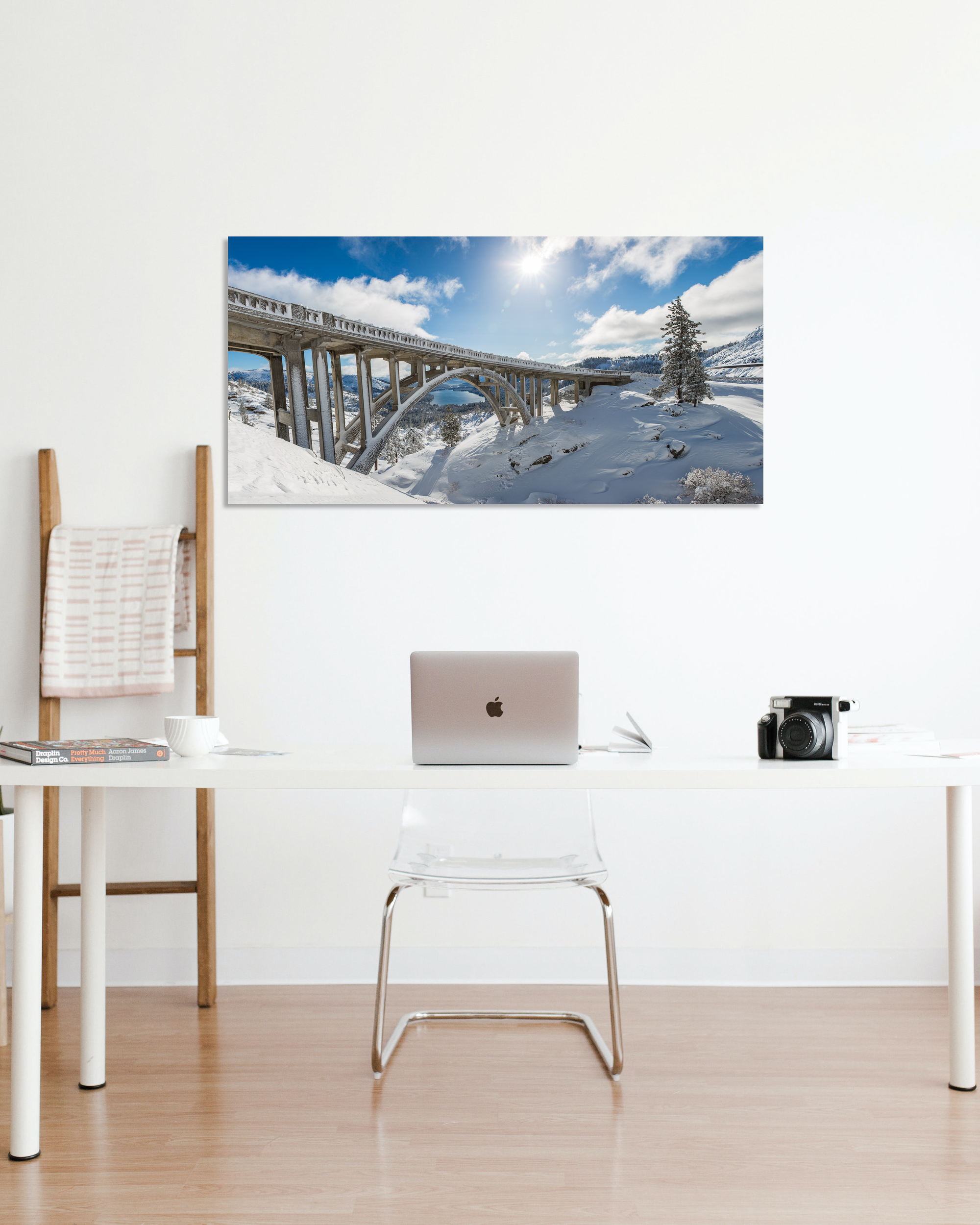 A landscape image showcasing a bridge hangs on an office wall.