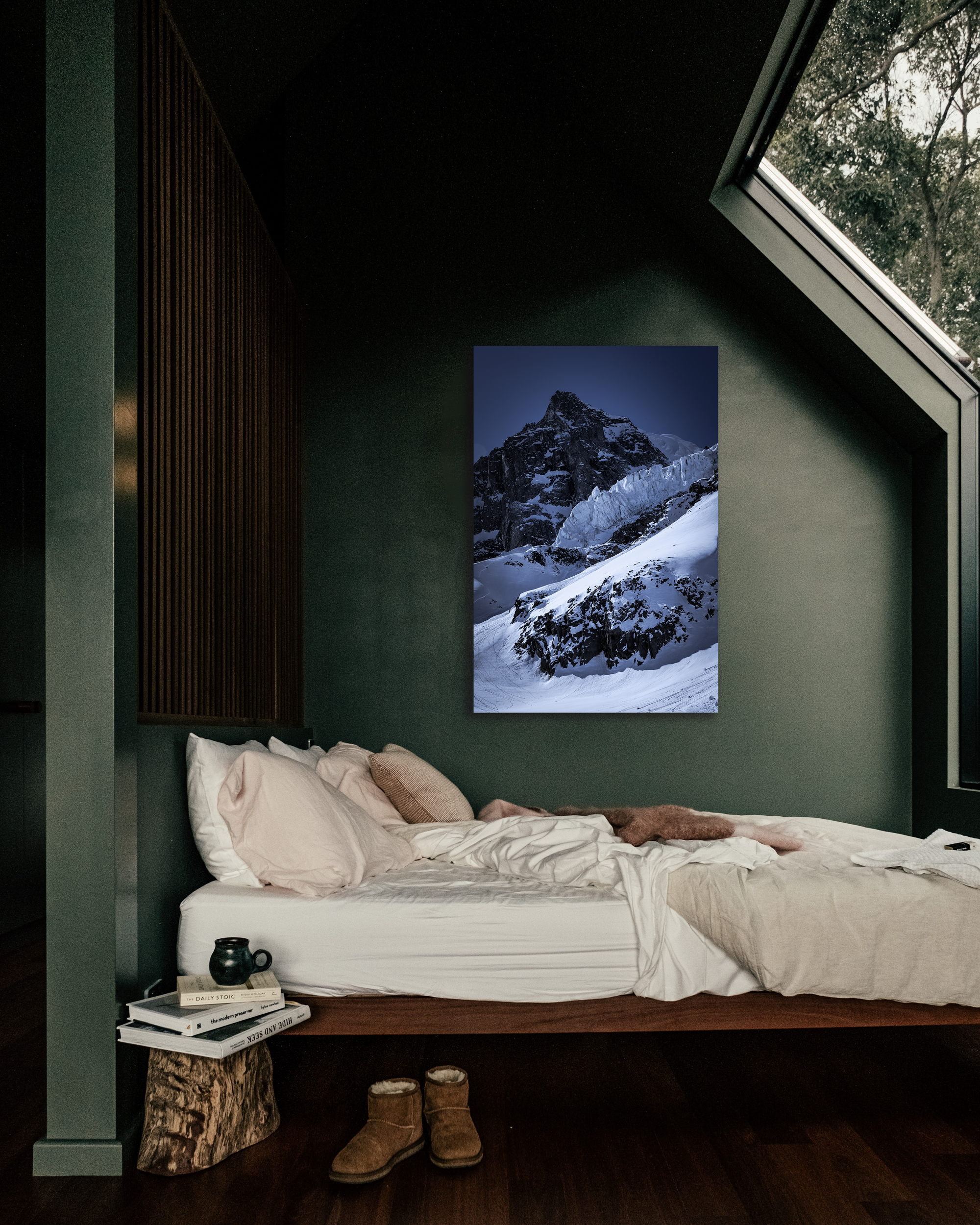 A cozy bedroom showcases a glacier laden image on its wall.