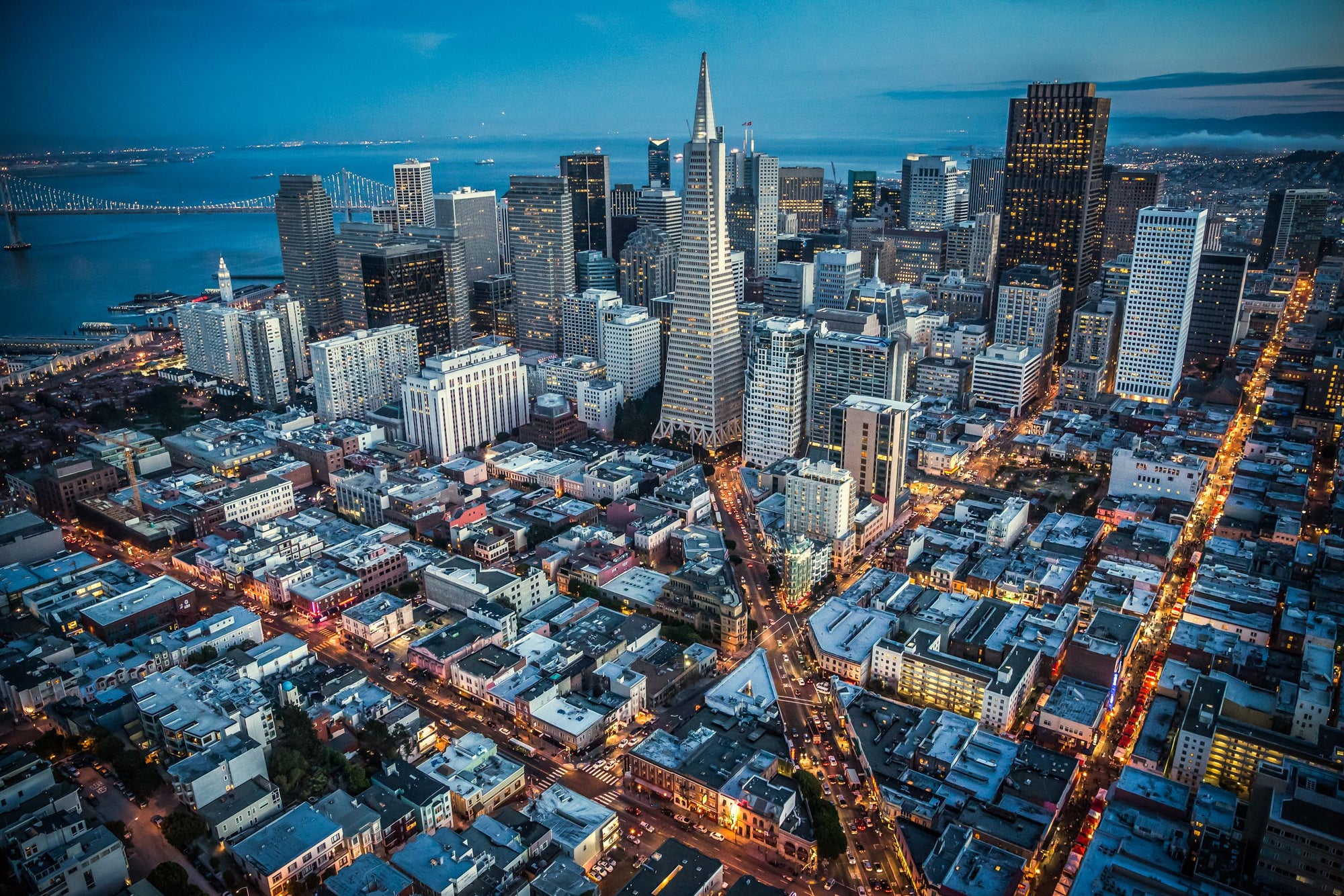 Traffic and city light glowing in the streets of San Fransisco at dusk.