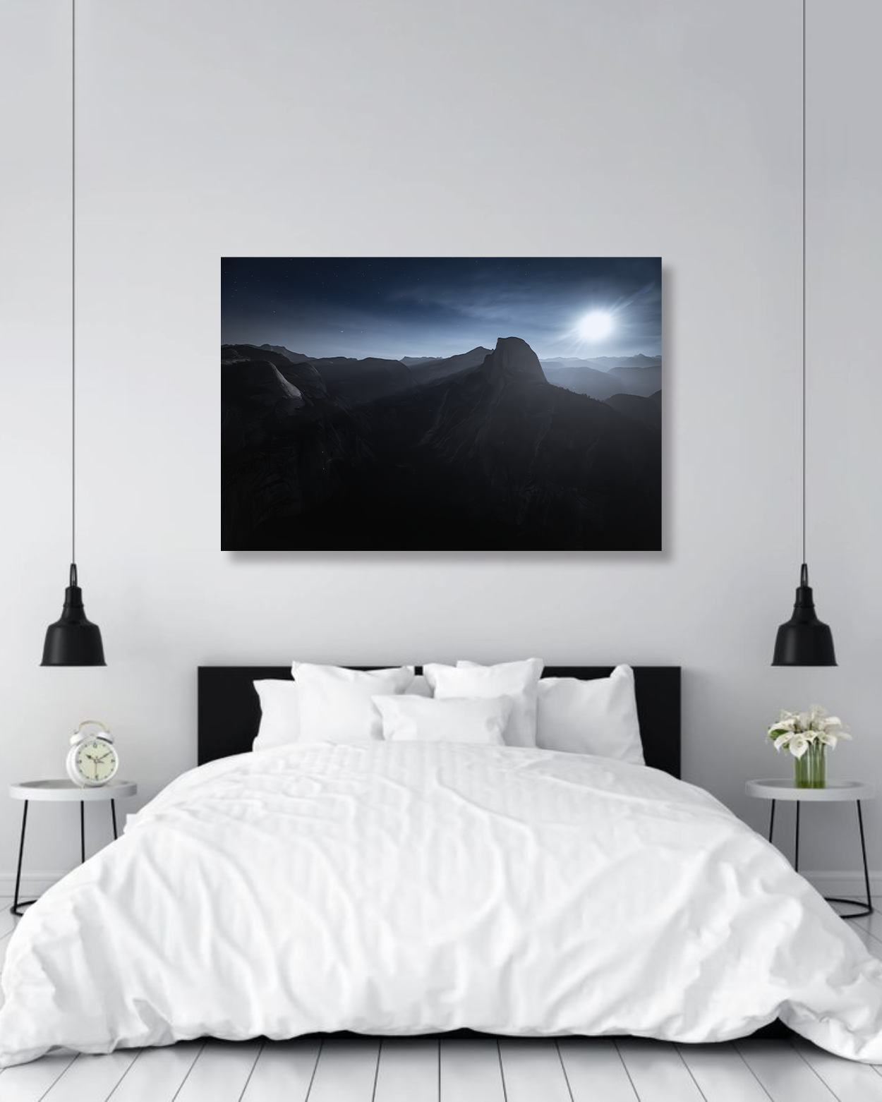 A large photograph of Half Dome with the moorising hangs above a large bed.