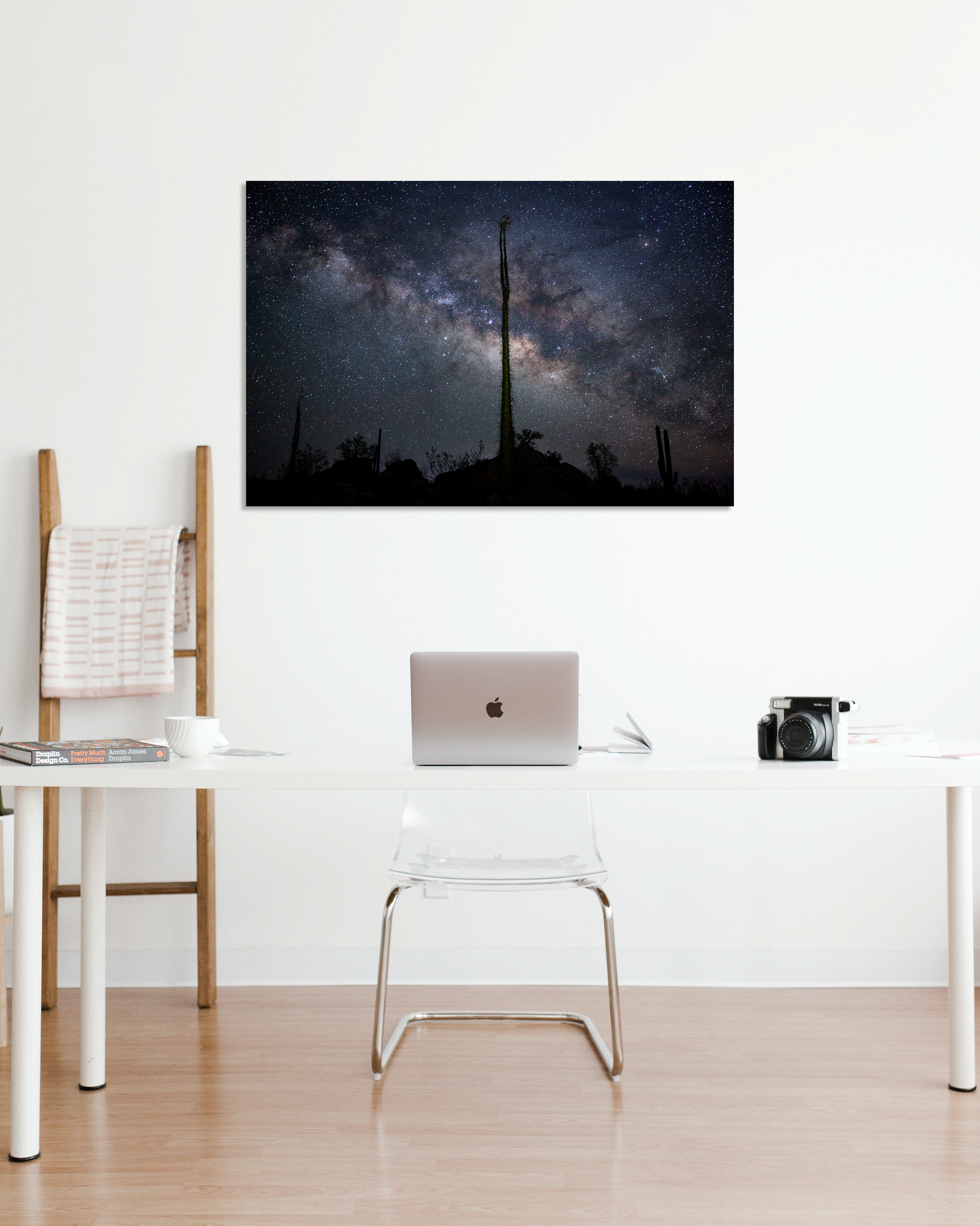 A fine art photo of the Milky Way adorns and office wall.