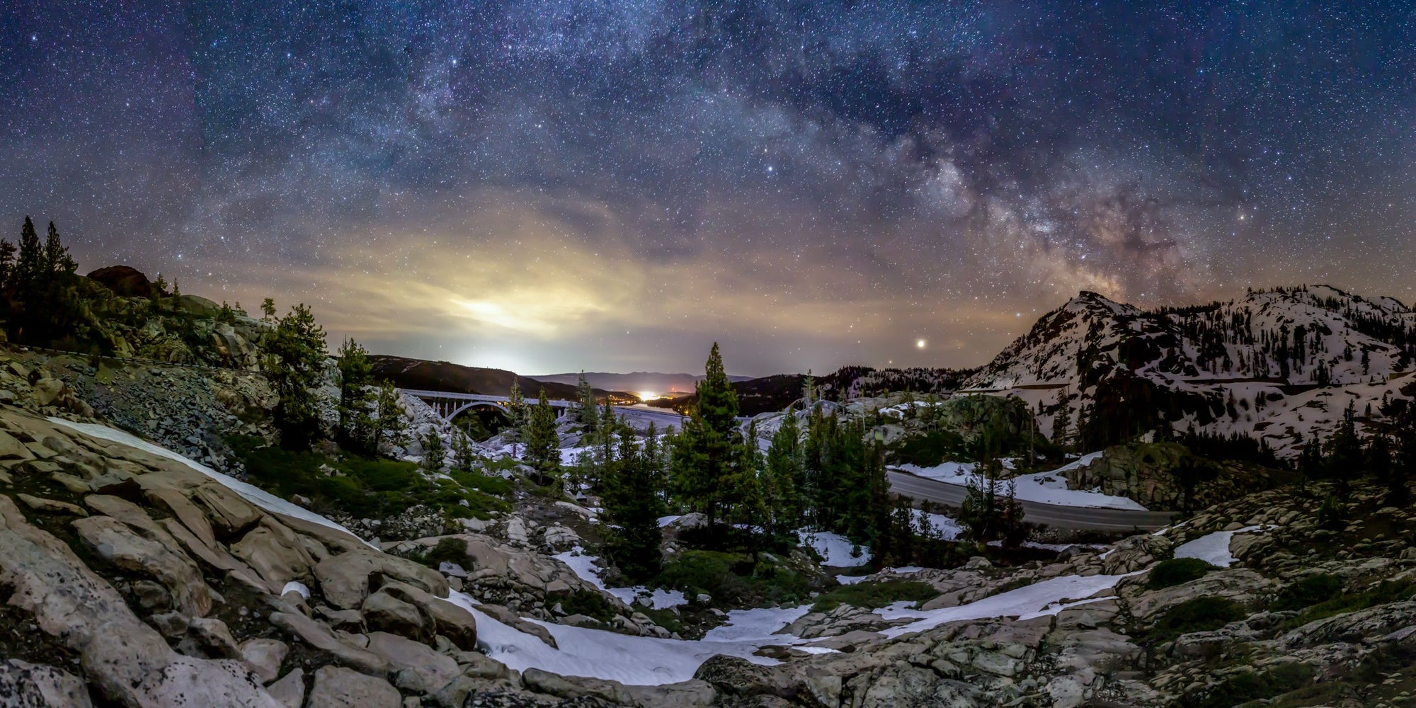 The Milky Way arches above the granite slopes on old highway 40 near Donner Lake.