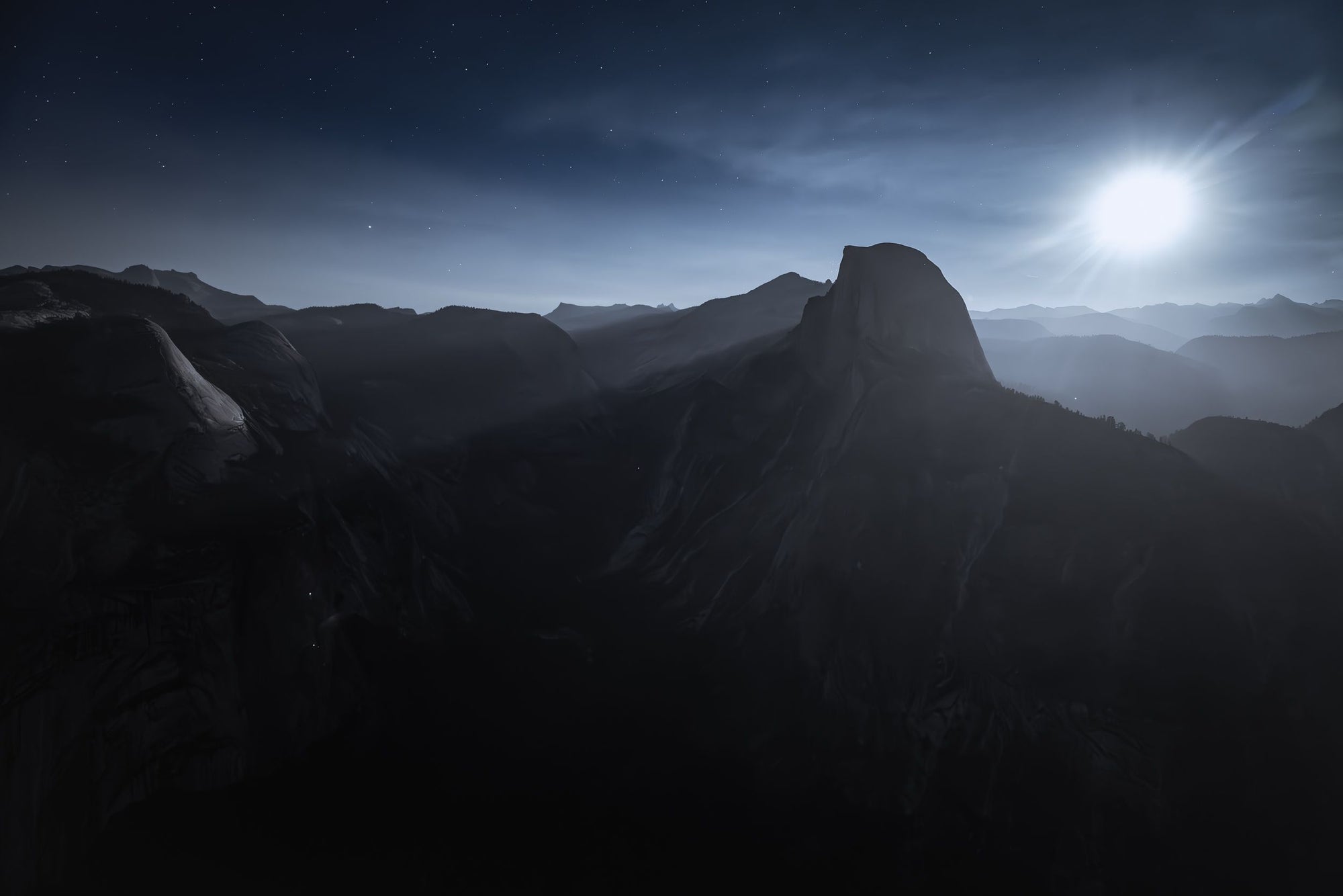 A full moon rises above Half Dome in Yosemite.
